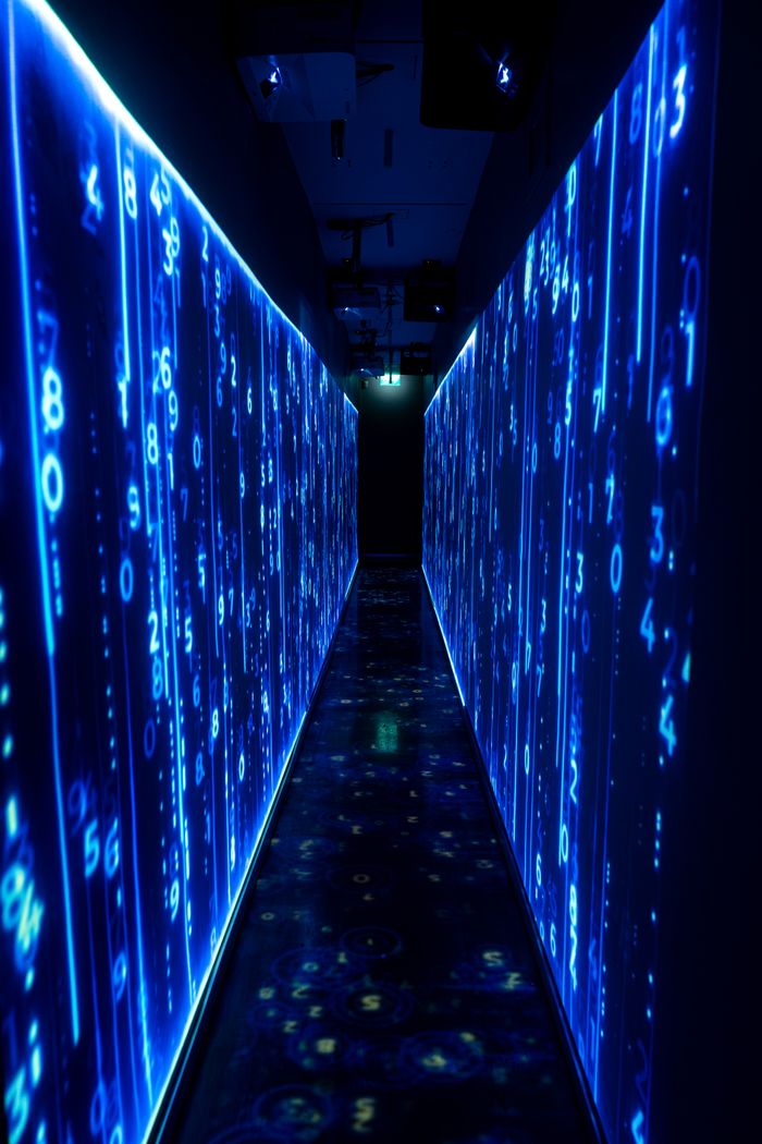 hero-img-01 A luminous blue tunnel with digital numbers creating a futuristic, sci-fi ambiance.