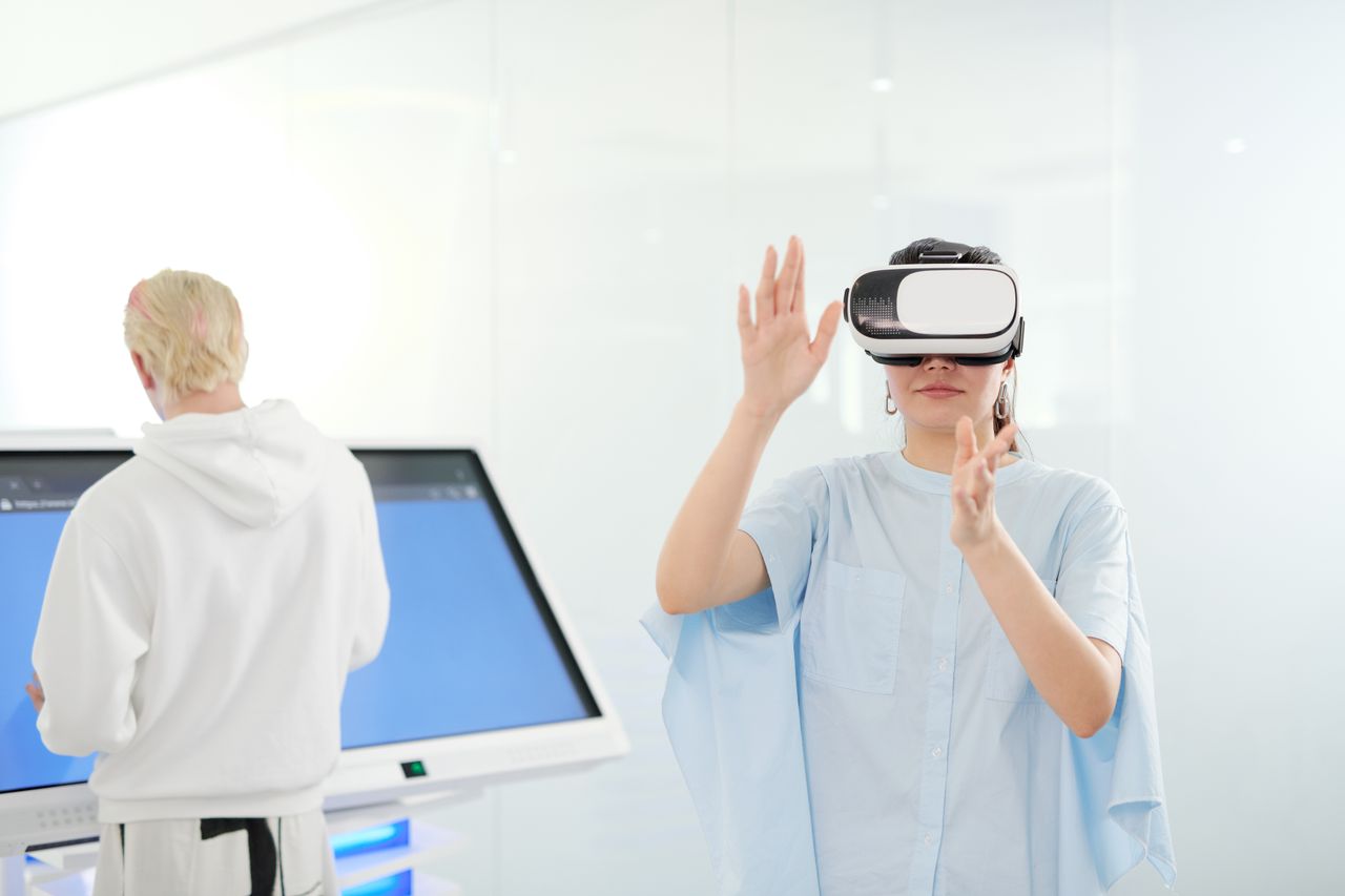 services-03 Woman exploring virtual reality with VR goggles in a modern technological environment.
